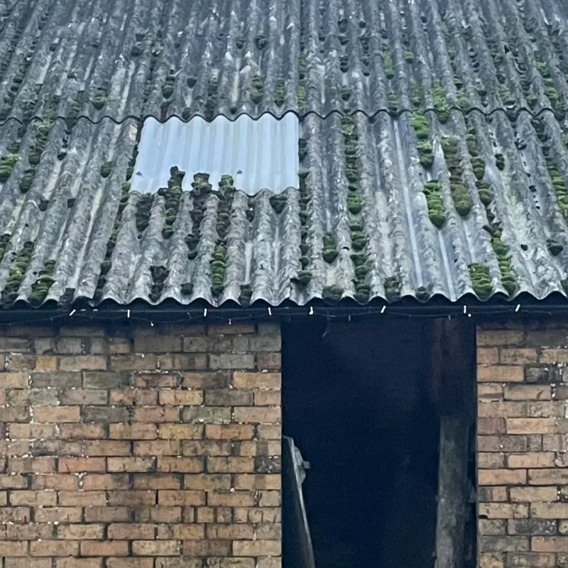 A close up shot of an ageing asbestos roof on a farm building in North Yorkshire