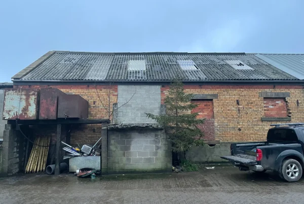 A farm calving shed with a corrugated asbestos roof