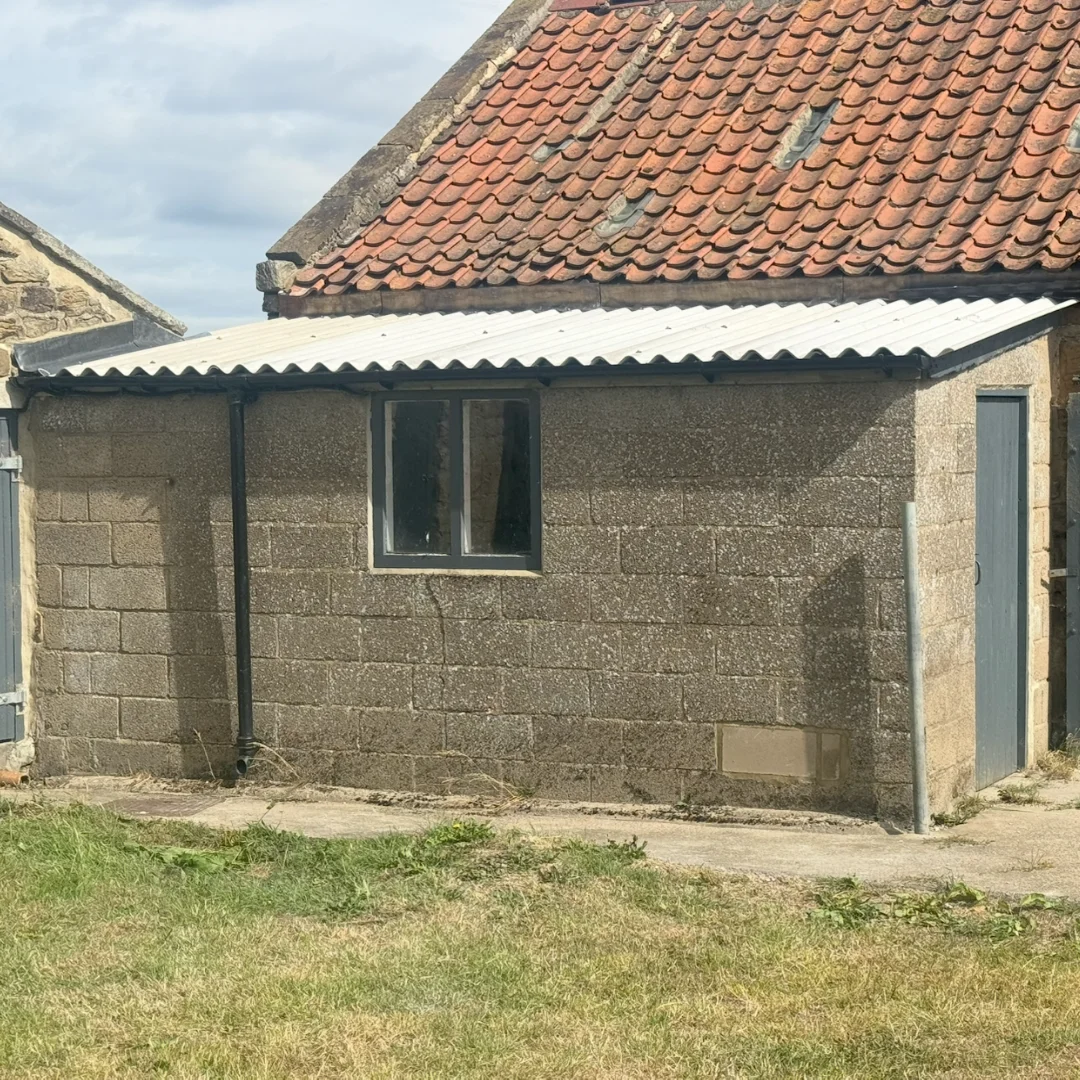 A breeze nlock-built outbuilding with a new corrugated roof